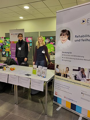 Mitarbeitende stehen am Infostand